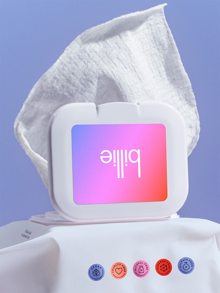 White facial cleansing wipe container with purple-pink gradient logo, displayed with wipe and colorful certification badges.