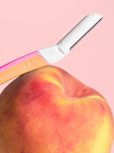 malibu dermaplane handle resting on a peach