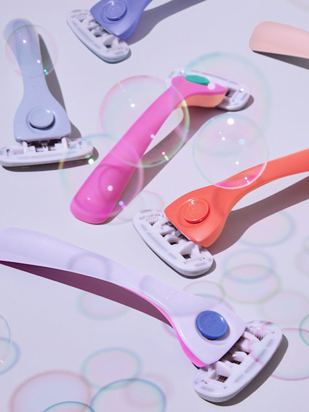 Light blue razor, purple razor, pink and orange razor, orange razor, light pink razor, purple and pink razor with bubbles around them