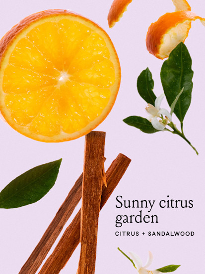 Oranges, flowers, and sandalwood on a pink background
