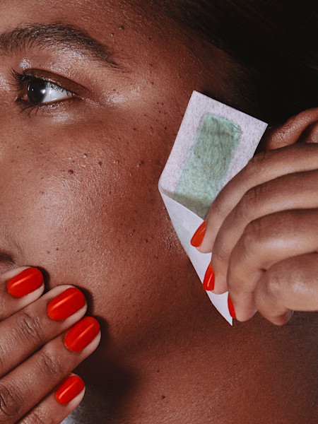 model using face wax strip on their cheek
