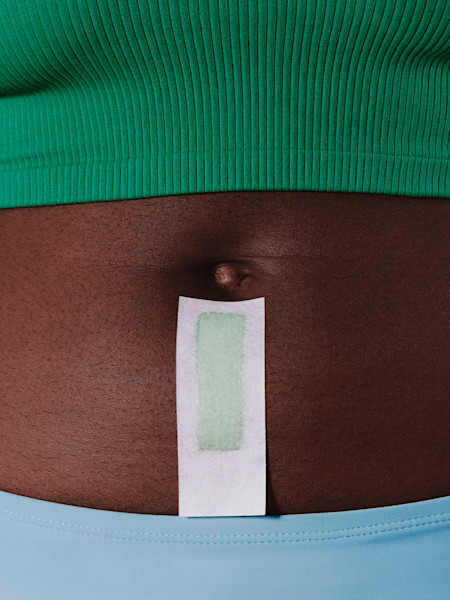 model using bikini wax strip on stomach