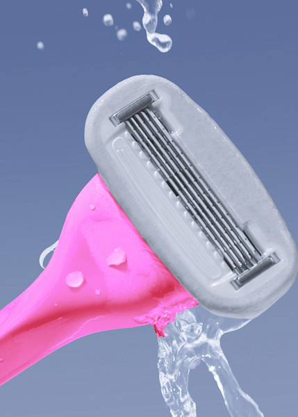 pink razor being splashed with water