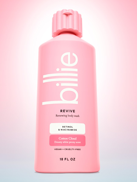 Pink revive body wash bottle in front of a pink gradient background