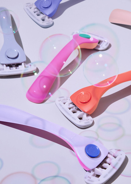 Light blue razor, purple razor, pink and orange razor, orange razor, light pink razor, purple and pink razor with bubbles around them