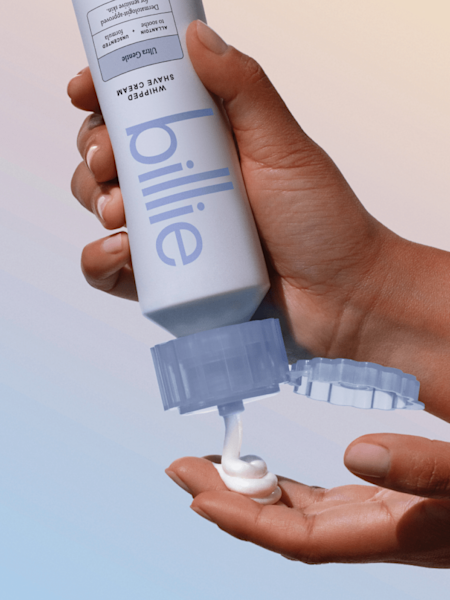 Model squeezing ultra gentle shave cream out of bottle into her hands