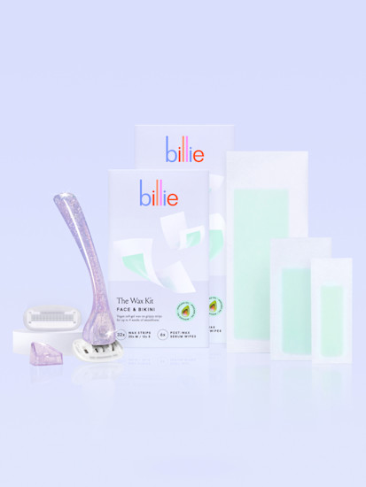 Glitter razor with an extra blade and holder alongside face & bikini wax kit box and strips and body & underarm wax kit box and strips against a light gray background