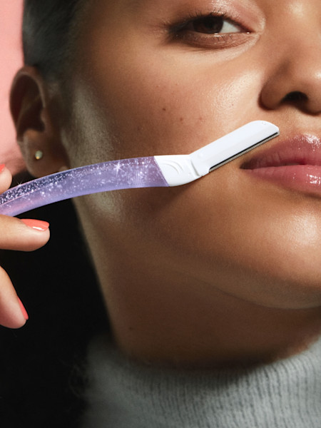 model using sparkle dermaplane on her upper lip