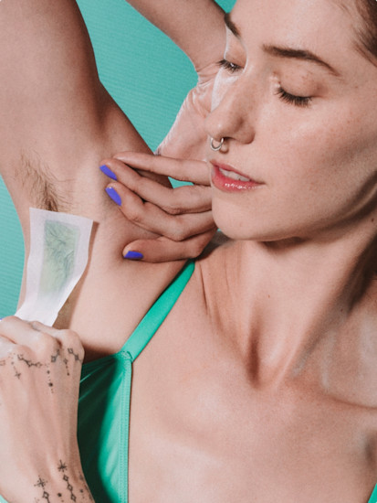 Woman using Billie Body & Underarm Wax Strip to remove hair from her underarm