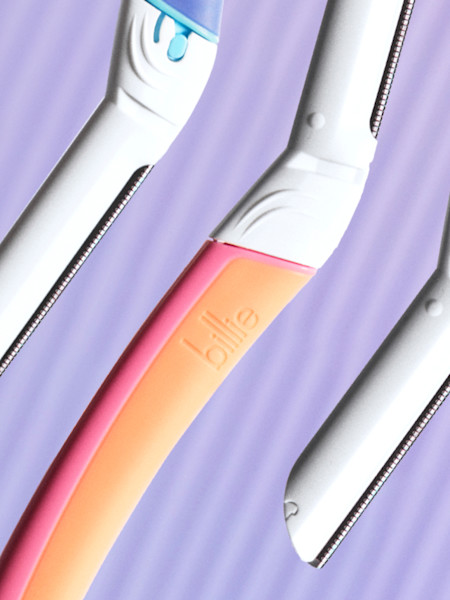 stylized image of dermaplane handles in waterpark, malibu, and sparkle in front of a light purple background