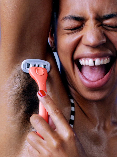 Model shaving underarm with coral razor