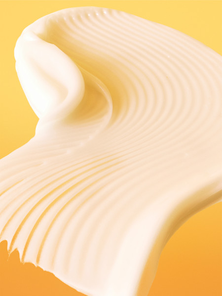 glow lotion texture shot on a yellow background