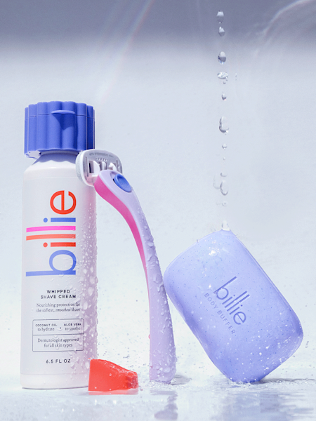 image that contains the whipped shave cream bottle in lavender, and the purple razor leaning on the shave cream bottle and the purple body buffer bar leaning on the razor
