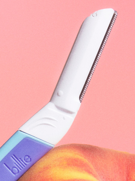 waterpark dermaplane handle resting on a peach