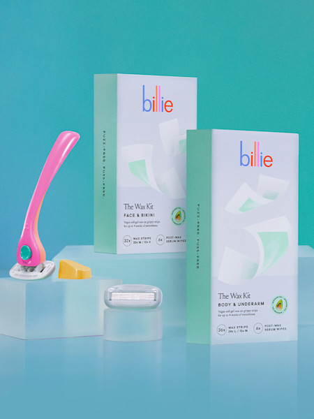 pink and teal razor with yellow magnetic holder, an extra blade next to the body & underarm and face & bikini wax kits boxes