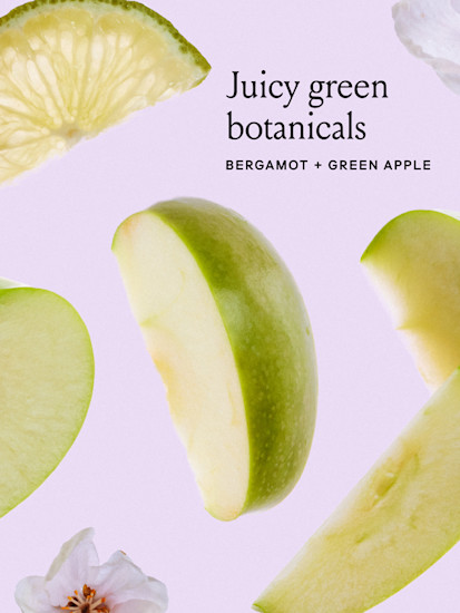  Lime apple and flowers on a pink background with black text that says juicy green botanicals, bergamot & green apple